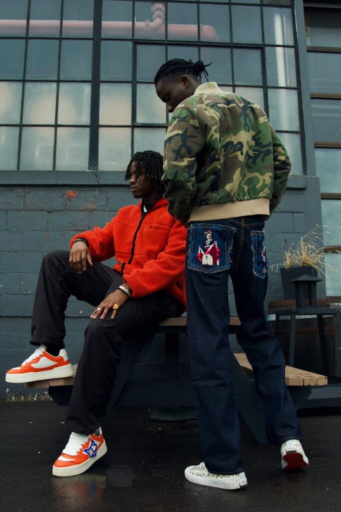 Two men sitting on a bench in front of a building